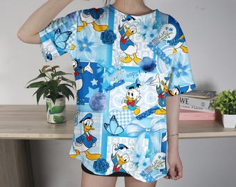 Camiseta divertida del Pato Donald para adultos y adolescentes, adorable camiseta de pato de dibujos animados con estampado floral azul, camiseta unisex 3D, ideal para regalar.