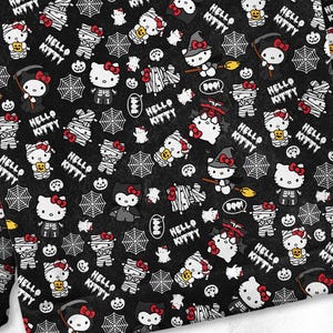 May include: Black fabric with a repeating Halloween-themed pattern featuring Hello Kitty characters dressed as mummies, vampires, and witches. The design includes spiderwebs, pumpkins, and the text "HELLO KITTY".