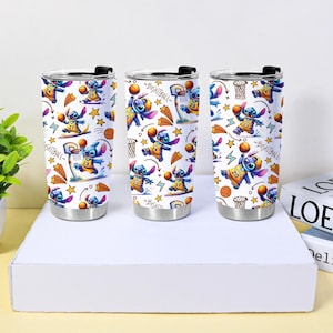 May include: Three stainless steel tumblers with a basketball-themed design featuring the character Stitch. The design includes Stitch playing basketball, basketball hoops, stars, and lightning bolts on a white background. Each tumbler has a black lid.