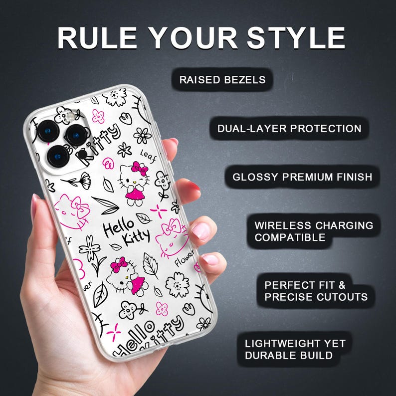 May include: Clear phone case featuring a Hello Kitty design with pink accents and black outlines. The case has a glossy finish and is decorated with flowers, bows, and the text "Hello Kitty". The case is held in a hand.