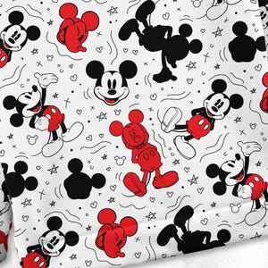 May include: White fabric featuring a repeating pattern of Mickey Mouse in various poses. Mickey is shown in red shorts, black shoes, and a smiling face. The background includes hearts, stars, and other doodles. The design is suitable for clothing.