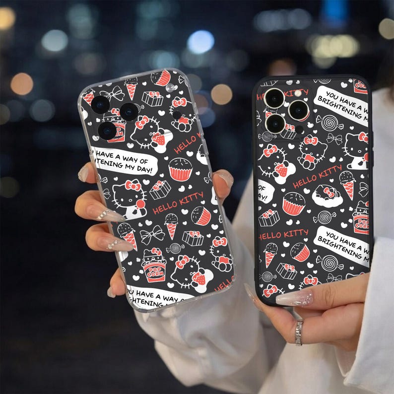 May include: Two black phone cases with a repeating pattern of Hello Kitty, cupcakes, ice cream, and bows in white and red. One case has the text "HAVE A WAY OF BRIGHTENING MY DAY!" and "HELLO KITTY".