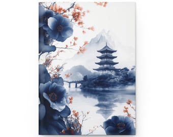 May include: A journal with a serene Japanese landscape design. The cover features a pagoda, mountains, and a lake, with blue flowers and orange blossoms framing the scene. The artwork is a watercolor style.