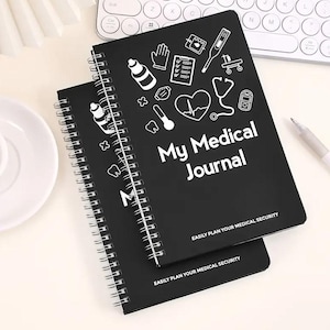 May include: Two black spiral bound journals with white medical icons and the text "My Medical Journal" and "EASILY PLAN YOUR MEDICAL SECURITY".