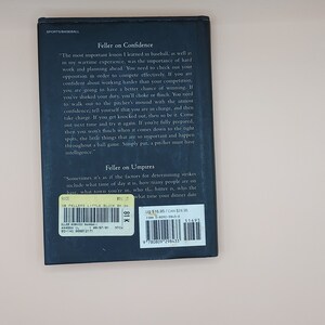 May include: A blue book with the title "Feller on Confidence" and "Feller on Umpires" on the back cover. The book is about baseball and features quotes from Hall of Fame pitcher Bob Feller. The book is priced at $16.95 USD.