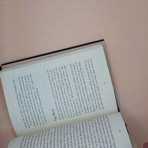 May include: A close-up of a page from a book with black text on a white background. The text discusses the career of Yogi Berra, a famous baseball player. The text mentions that Yogi Berra was a great hitter, catcher, and outfielder. The text also mentions that Yogi Berra was a three-time MVP award winner.
