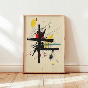 May include: Abstract art print in a wooden frame. The artwork features a black geometric design with red, yellow, and teal accents on a cream background. The print is displayed on a wooden floor against a white wall.