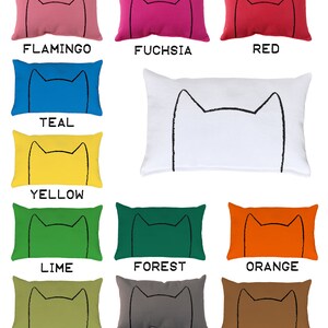 May include: A set of 12 decorative throw pillows with a cat face design in various colors, including flamingo, fuchsia, red, teal, yellow, lime, forest, orange, avocado, gray, and mocha brown.