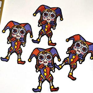 May include: Four embroidered iron-on patches featuring a cartoon jester with a red, yellow, and blue costume. The jester has large, round eyes and a surprised expression.