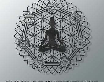 May include: Black metal wall art featuring a meditating figure within a geometric design. The artwork includes symbols representing chakras and a flower of life pattern. The size is adjustable, with the downloaded page measuring 50x50 cm.