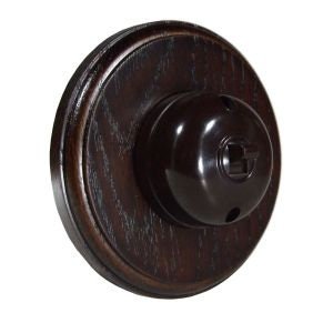 May include: A dark brown wooden ceiling light fitting with a black bakelite socket and a round, dark brown wooden base.