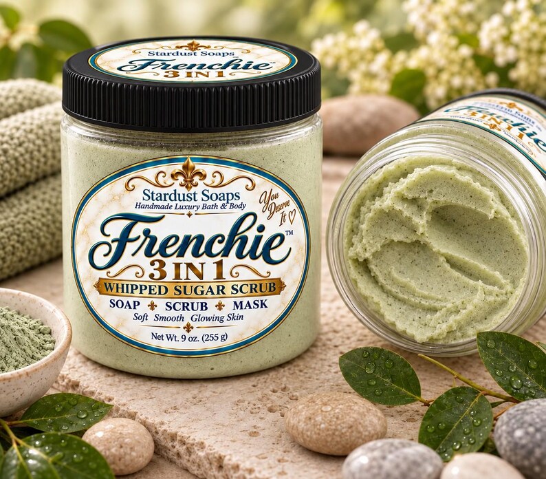 May include: A clear plastic jar of Stardust Soaps Frenchie 3 in 1 whipped sugar scrub with a black lid. The label reads Frenchie 3 in 1 Whipped Sugar Scrub, Soap, Scrub, Mask, Net Wt. 9 oz. (255 g). The scrub inside is a pale green, textured paste.