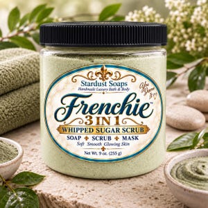 May include: A clear plastic jar with a black lid containing light green whipped sugar scrub. The label reads Stardust Soaps Frenchie 3 IN 1 WHIPPED SUGAR SCRUB SOAP SCRUB MASK Net Wt. 9 oz. (255 g) with decorative gold and blue accents.