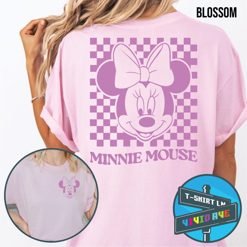 May include: Pink t-shirt with a checkered pattern and a purple Minnie Mouse graphic. The text "Minnie Mouse" is printed below the graphic. The t-shirt is available in sizes S-XL.