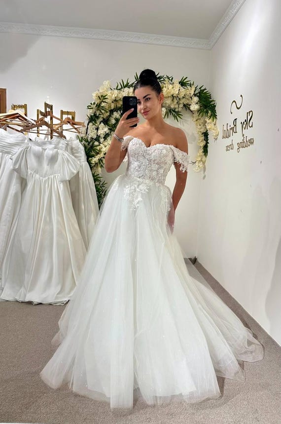 Aラインのアイボリーウェディングドレス、シースルーコルセットと  