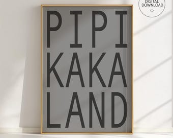 May include: A framed art print featuring the words "PIPI KAKA LAND" in bold, black lettering against a grey backdrop. The frame is gold-coloured. A small, circular graphic in the top right corner says "DIGITAL DOWNLOAD".