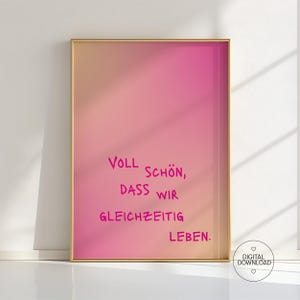 Może przedstawiać: Oprawiony wydruk z gradientowym tłem w kolorze brzoskwiniowym i różowym. Tekst "Voll Schön, dass wir gleichzeitig leben" jest napisany różowym pismem. Ikona pobierania cyfrowego znajduje się w prawym dolnym rogu.