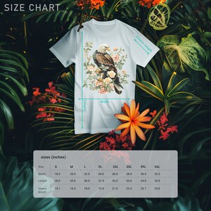 May include: Size chart for a t-shirt with a graphic of a bald eagle perched on a branch with pink flowers. The chart shows measurements in inches for width, length, and sleeve length for sizes S through 5XL.