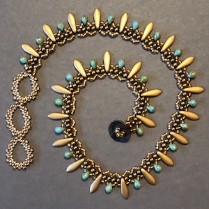 May include: A gold and turquoise beaded necklace with a decorative button closure. The necklace features a repeating pattern of gold beads and turquoise beads, with gold teardrop-shaped beads hanging from the bottom.