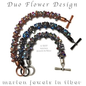May include: Two bracelets with a flower design. The bracelets are made with iridescent beads in shades of copper, black, and blue. The bracelets have toggle clasps.
