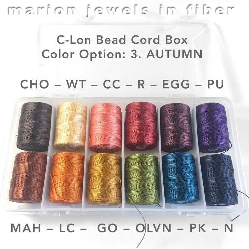 May include: A clear plastic box filled with spools of colorful thread. The box is labeled "C-Lon Bead Cord Box" and "Color Option: 3. AUTUMN". The spools are labeled with abbreviations like "CHO", "WT", "CC", "R", "EGG", "PU", "MAH", "LC", "GO", "OLVN", "PK", and "N".