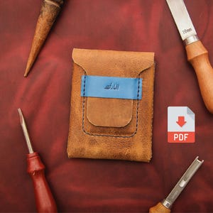 May include: A handmade brown leather wallet with a blue accent and stitching. The wallet has a blue band with text. Crafting tools surround the wallet, including a knife and awls. A PDF icon is also present.