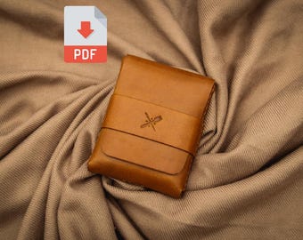 May include: A brown leather card holder with a subtle embossed design. The card holder has a flap closure and a single compartment.