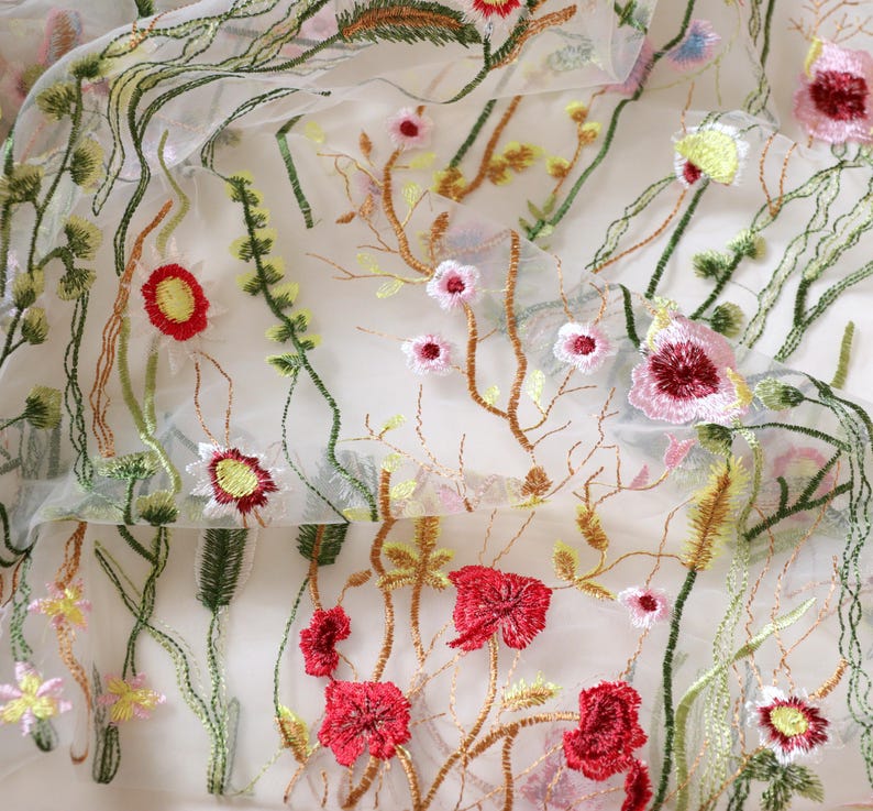 May include: White sheer fabric with embroidered floral designs in shades of red, pink, yellow, and green.