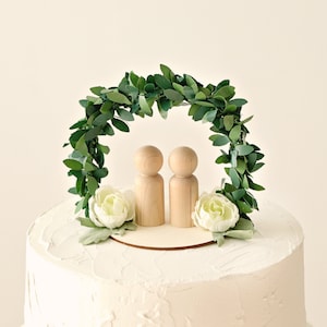 Wedding cake topper with greenery arch