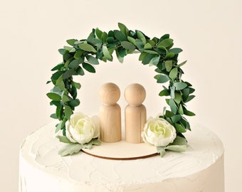 Wedding cake topper with greenery arch