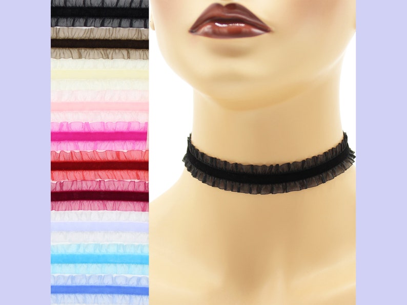 May include: A black choker necklace with a ruffled trim. The choker is made of a soft, stretchy material and is adjustable to fit most neck sizes.