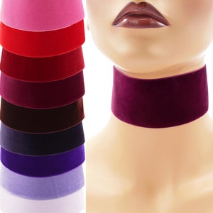 May include: A stack of ten velvet choker necklaces in various colors, including pink, red, burgundy, brown, navy, purple, lavender, and white.