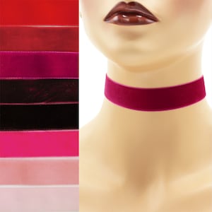 May include: A close-up of a velvet choker necklace in a deep magenta color. The choker is worn on a mannequin's neck. The image also shows a variety of other velvet ribbon colors in the background.