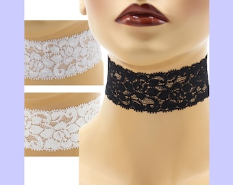 May include: A black lace choker necklace is displayed on a mannequin. Two white lace choker necklaces are shown in the background. The chokers feature a floral pattern. The background is a light purple color.