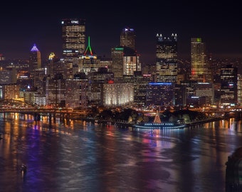 Pittsburgh Shine — The view of Pittsburgh is reflected in the 3 rivers during Light Up Night.