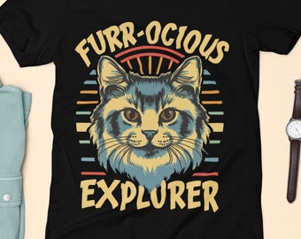 May include: Black t-shirt with a retro-style graphic of a cat's face and the text "FURR-OCIOUS EXPLORER".