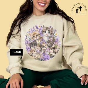 Gildan 18000 sweatshirt with vintage-style illustration of six playful kittens among lavender and wildflowers; cozy cottagecore cat lover crewneck for nostalgic and whimsical fashion.