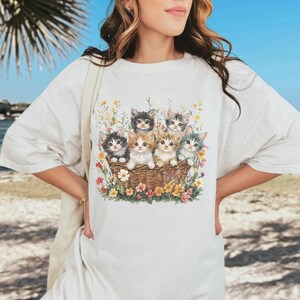 Comfort Colors 1717, 100% cotton t-shirt with a charming vintage-style illustration of six adorable kittens sitting together in a wicker basket surrounded by vibrant wildflowers