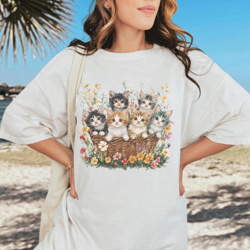 Comfort Colors 1717, 100% cotton t-shirt with a charming vintage-style illustration of six adorable kittens sitting together in a wicker basket surrounded by vibrant wildflowers