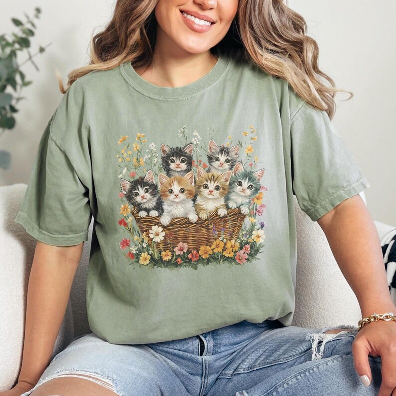 Comfort Colors 1717, 100% cotton t-shirt with a charming vintage-style illustration of six adorable kittens sitting together in a wicker basket surrounded by vibrant wildflowers