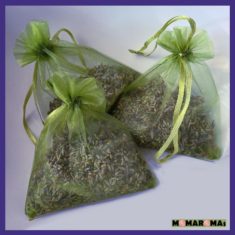 May include: Three green mesh bags filled with dried lavender. The bags have a drawstring closure and are tied with a green ribbon.
