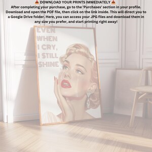 May include: A framed print featuring a vintage illustration of a woman with red lipstick and blue eyes. The woman is crying and the text on the print reads "EVEN WHEN I CRY, I STILL SHINE".