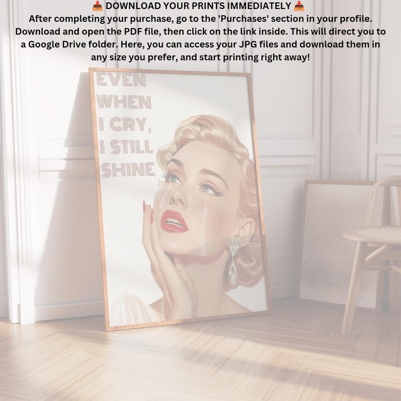 May include: A framed print featuring a vintage illustration of a woman with red lipstick and blue eyes. The woman is crying and the text on the print reads "EVEN WHEN I CRY, I STILL SHINE".
