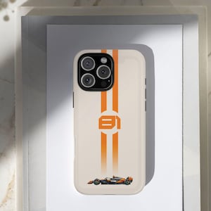 May include: A cream-colored phone case featuring two vertical orange stripes and the number "91" in orange. A small race car graphic is at the bottom. The case has a black camera module and black side buttons.