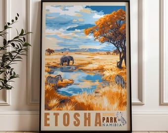 May include: A framed travel poster featuring a landscape of Etosha National Park in Namibia. The illustration depicts a blue watering hole, a grey elephant, two zebras, and an orange-leafed tree under a blue sky. Text reads ETOSHA NATIONAL PARK NAMIBIA.
