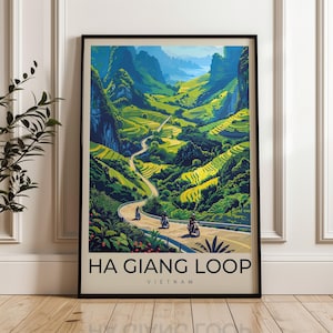 May include: Framed art print of the Ha Giang Loop in Vietnam. The artwork shows a winding road through a green valley with terraced fields and mountains. Three motorbikes are on the road. The text "HA GIANG LOOP VIETNAM" is at the bottom.