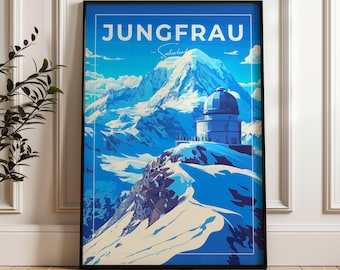 May include: A framed travel poster featuring the Jungfrau mountain in Switzerland. The artwork displays a snow-covered peak, a domed observatory building, and the text JUNGFRAU Switzerland in white against a vibrant blue sky background.