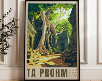 May include: A framed vertical art print depicting the Ta Prohm temple ruins in Cambodia, featuring a large tree with exposed roots growing over stone structures, with the text TA PROHM CAMBODIA printed in dark block letters at the bottom.