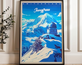 May include: A framed travel poster featuring a blue-toned illustration of the Jungfrau mountain in Switzerland. The artwork displays a domed observatory building on a snowy peak with the text SWITZERLAND and Jungfrau printed at the top.