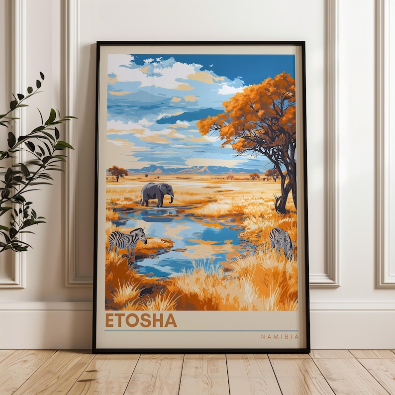A framed poster of Etosha, Namibia, showcasing a picturesque savannah scene. It features zebras grazing, an elephant near a reflective waterhole, and a striking orange acacia tree under a dramatic, cloud-filled sky with distant mountains.
